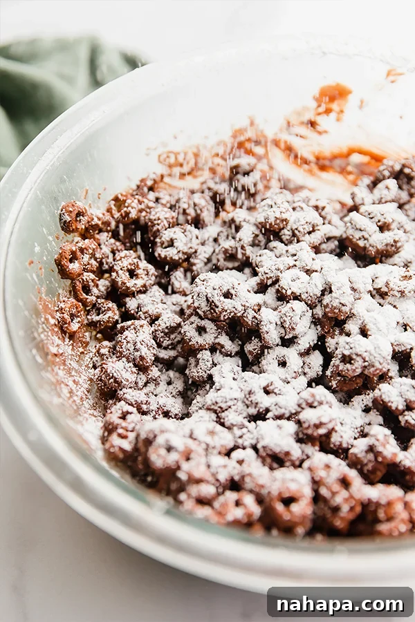 Sifting powdered sugar over chocolate-coated Lovebird cereal for puppy chow