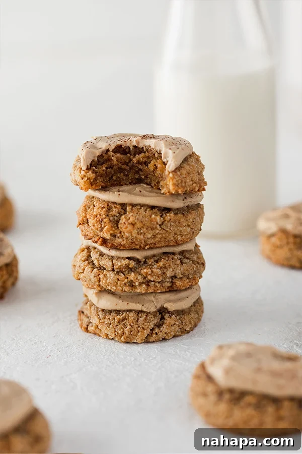 A delightful stack of Tiramisu cookies, generously frosted and dusted with cocoa powder, ready to be enjoyed.