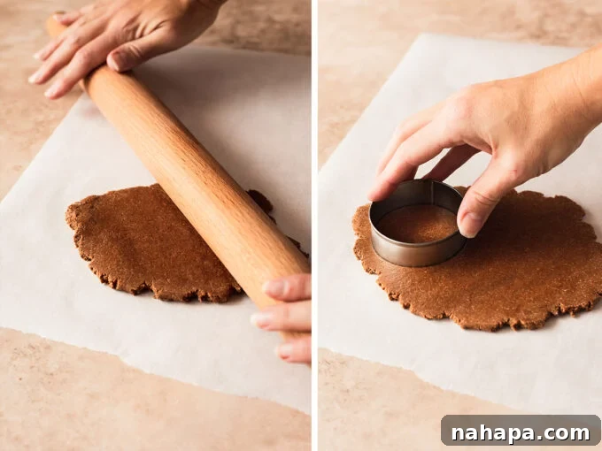 Chocolate Gingerbread Sandwich Cookies Paleo AIP 4 A rolling pin flattening chocolate gingerbread cookie dough on parchment paper, with a round cookie cutter ready to be used.