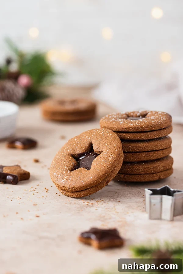 Chocolate Gingerbread Sandwich Cookies Paleo AIP 9 A beautiful stack of chocolate gingerbread sandwich cookies, generously filled and dusted with powdered sugar, ready to be enjoyed.