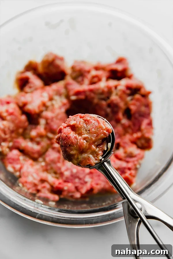 A close-up of the seasoned ground beef mixture for meatballs.