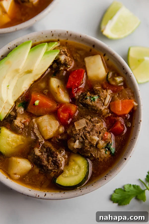 A beautifully presented bowl of Albondigas soup, ready to be enjoyed.