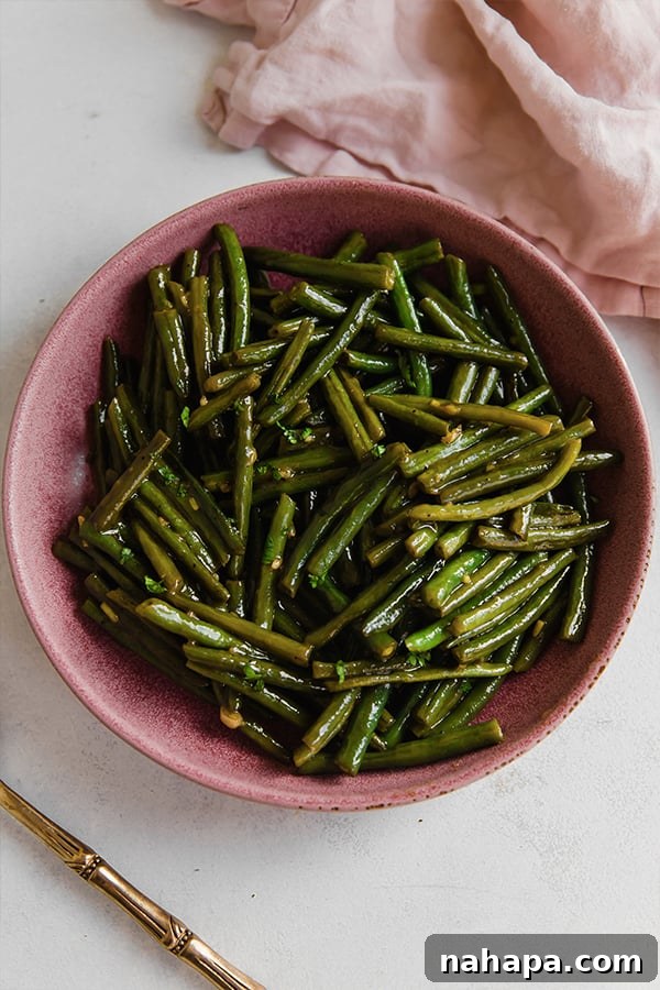 A beautifully presented bowl of sweet and sour Hungarian green beans, perfectly garnished and ready to be enjoyed as a side dish.