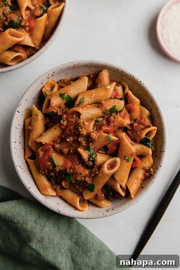 A bowl of Instant Pot Pasta, garnished with fresh parsley.