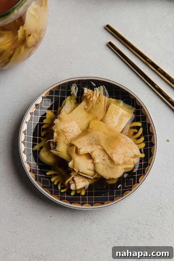 A bowl of freshly made pickled ginger, vibrant and thinly sliced, ready to be served as a healthy condiment.