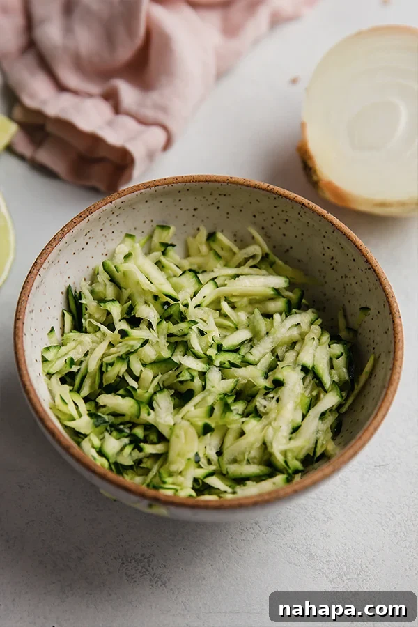 Wholesome Paleo Gluten-Free Ground Turkey Avocado Taquitos 3 A bowl of freshly shredded zucchini, prepared for mixing into the taquito filling.