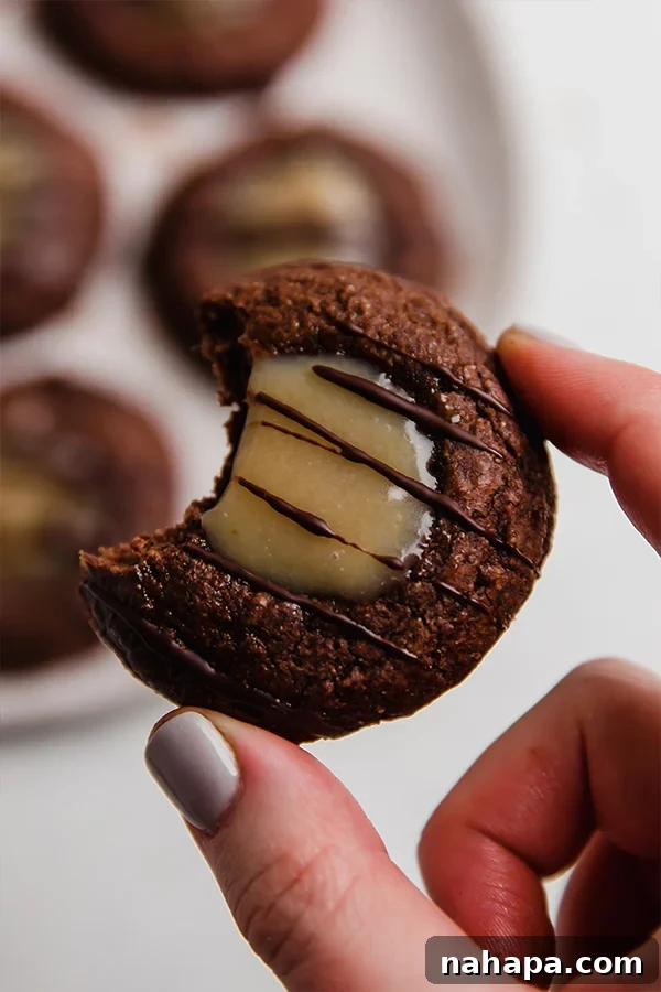 Adventureful Inspired Gluten Free Caramel Brownie Cookies 6 A copycat adventureful cookie with a bite taken out, showing the caramel filling.