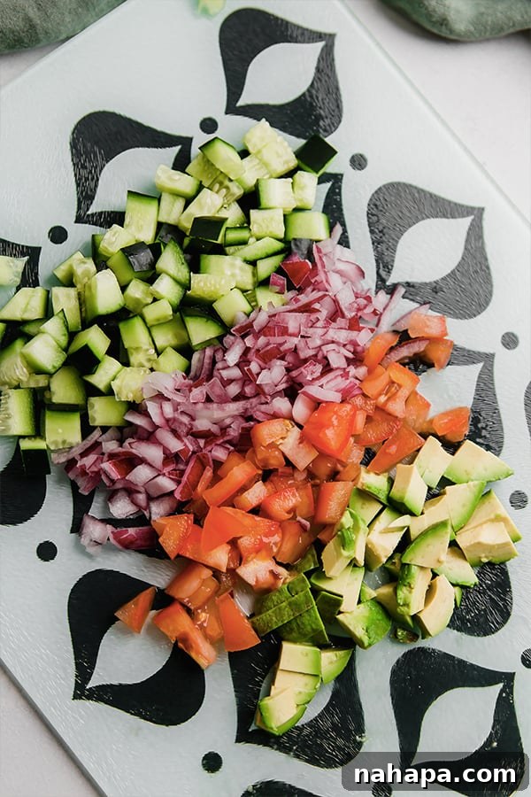 All the freshly chopped vegetables for the vibrant Greek Salsa, awaiting combination.