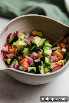 A bowl of chopped vegetables for Greek Salsa Salmon bowls.