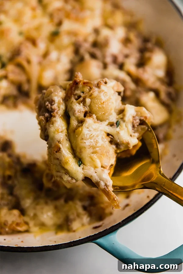 A serving of French Onion Gnocchi Skillet, showing the creamy sauce, gnocchi, and ground beef.