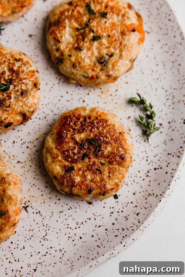 A plate with golden-brown turkey breakfast sausages on it, garnished with fresh herbs, offering a delightful and healthy start to the day.