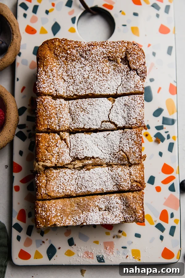 Wholesome Gluten Free Paleo Egg Free Applesauce Pound Cake 5 A loaf of paleo pound cake, sliced and ready to serve, showing its moist texture.