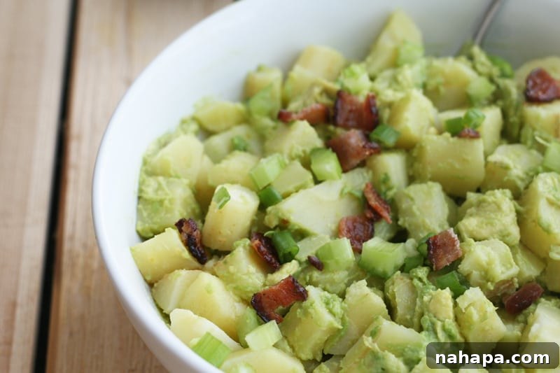 AIP Avocado "Potato" Salad with a creamy texture, garnished with fresh herbs.