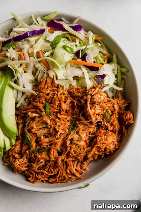 A perfectly assembled shredded BBQ chicken bowl, showcasing all the delicious components ready to be enjoyed.