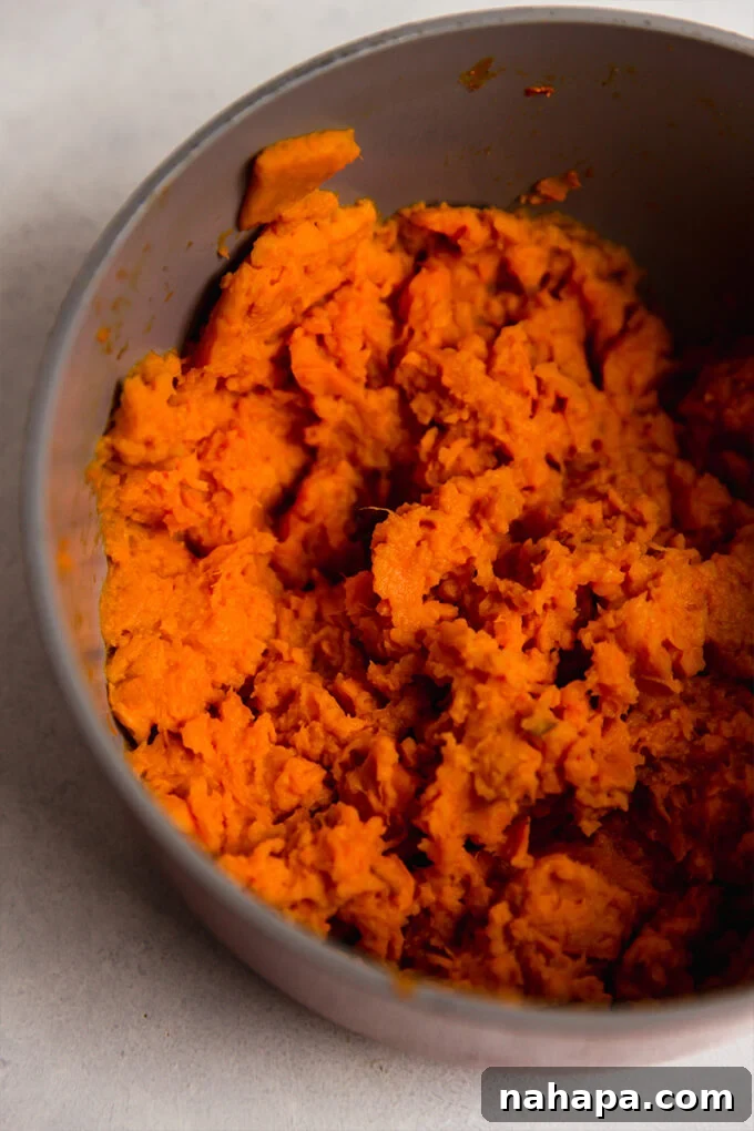 Mashed sweet potatoes in a bowl, ready for the topping.