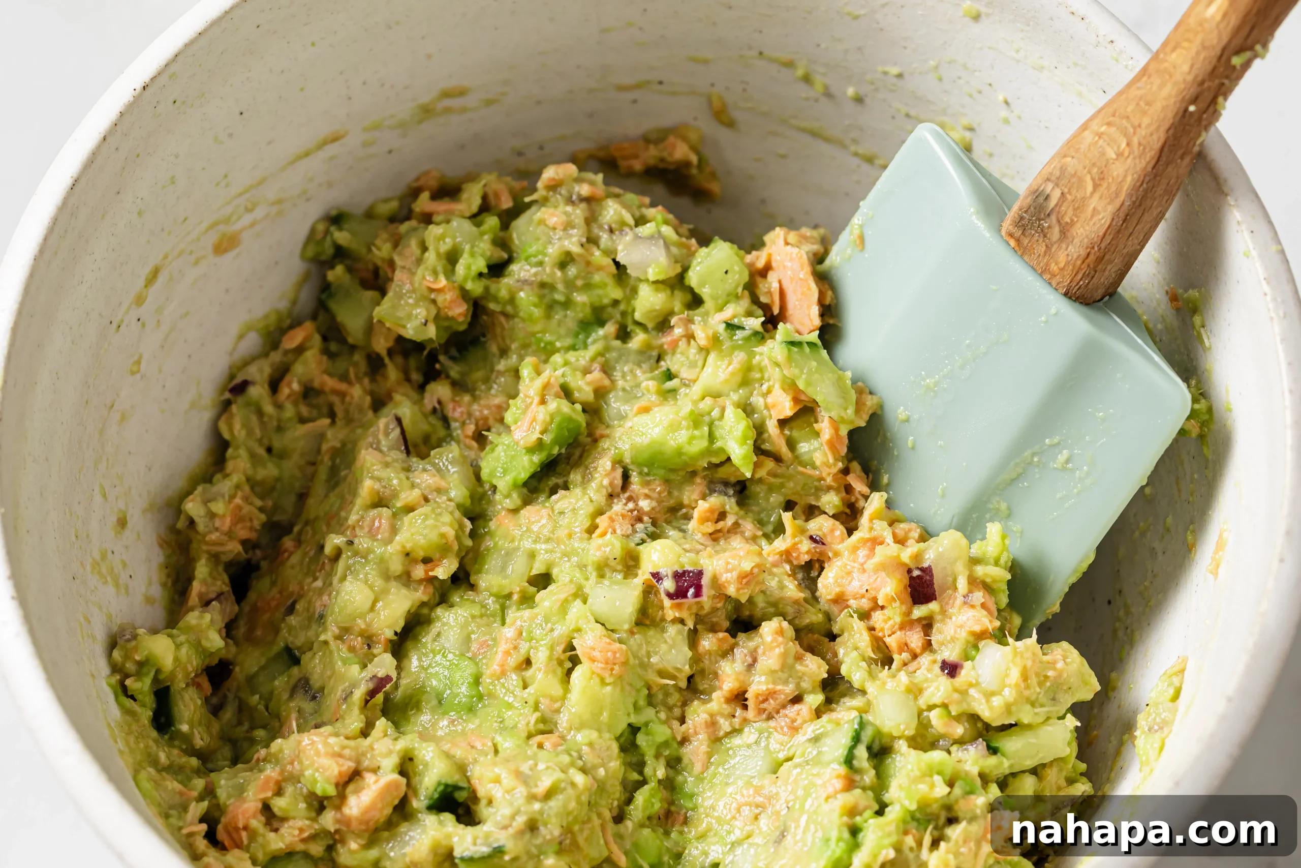 Diced cucumber, red onion, and celery added to the salmon and avocado mixture.