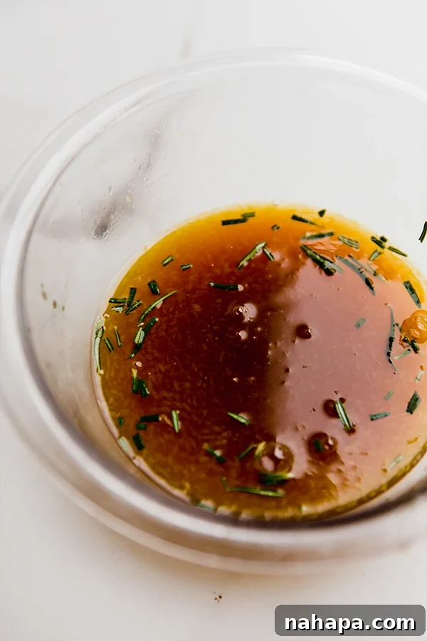 The marinade for citrus glazed chicken being whisked in a bowl.