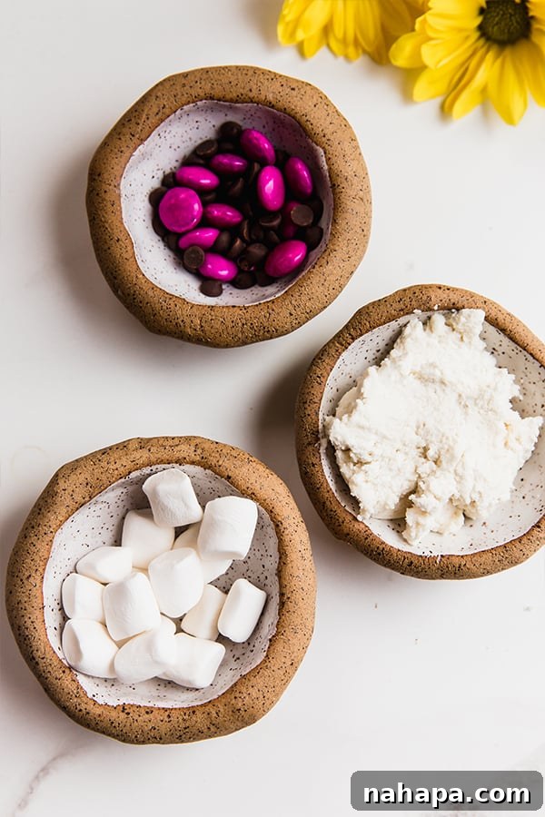 candy, frosting and marshmallows in bowls