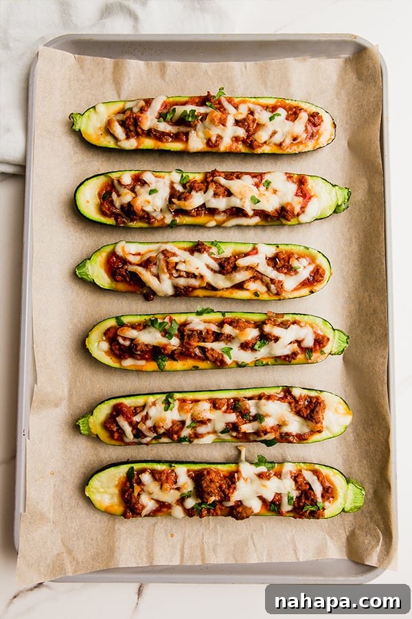 Loaded Beef Zucchini Boats 3 Easy beef stuffed zucchini on a sheetpan after baking.