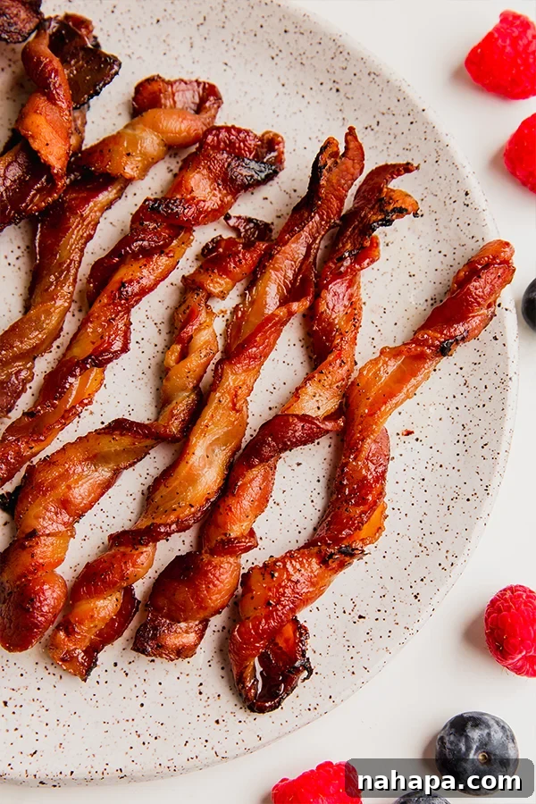 Golden Bacon Spirals 2 A plate of oven bacon twists, golden brown and perfectly cooked.