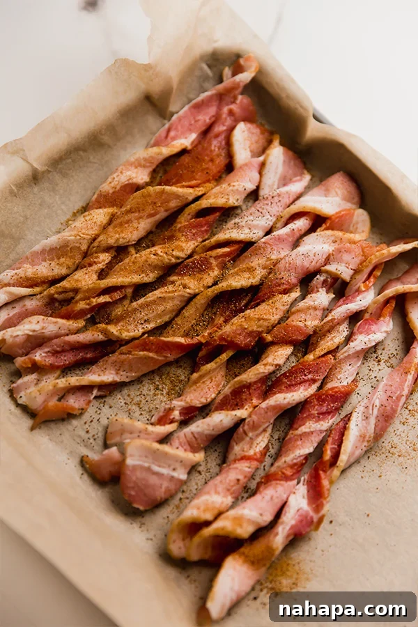 Golden Bacon Spirals 3 Oven bacon twists on a sheetpan before baking, seasoned with coconut sugar and black pepper.