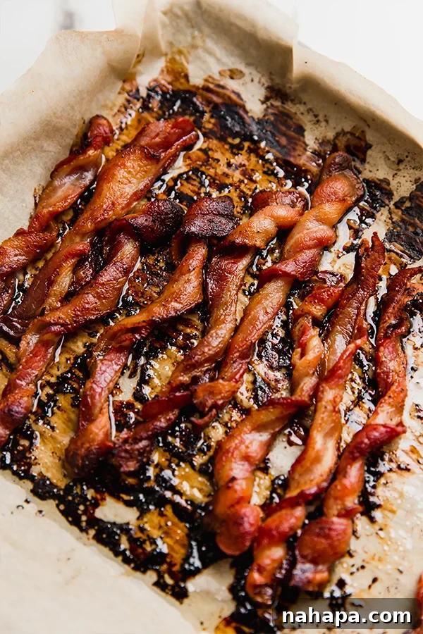 Golden Bacon Spirals 4 Oven bacon twists on a sheet pan after baking, glistening and crispy.