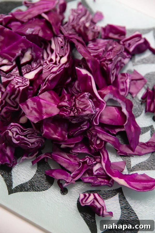 Freshly chopped red cabbage on a wooden cutting board, ready for preparing natural dye.