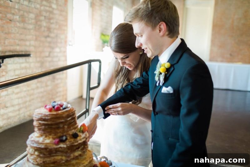 A close-up of the large, multi-tiered wedding cake, showing intricate details and decorations.