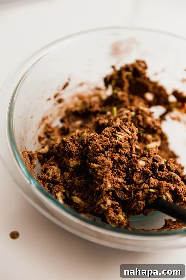 A bowl filled with the chocolate zucchini muffin batter, ready to be scooped into liners.