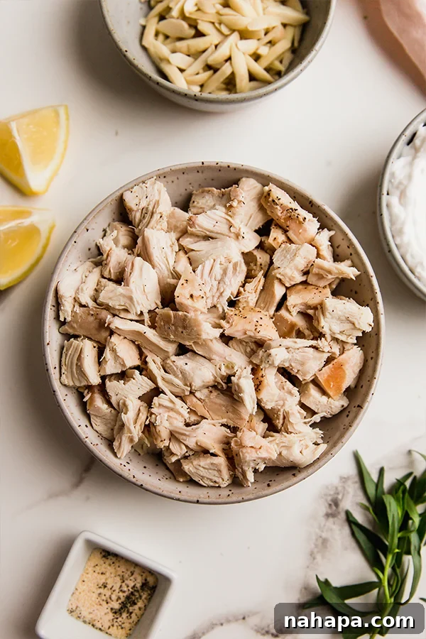 A bowl of diced cooked chicken, ready to be mixed into tarragon chicken salad.