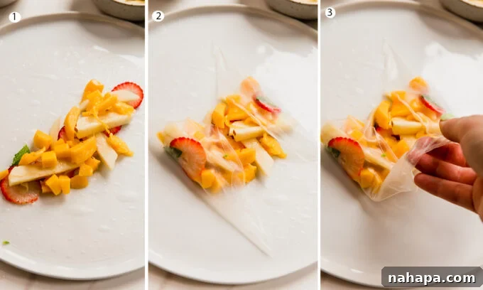 Refreshing Fruit Rice Paper Wraps with Tangy Yogurt Drizzle 4 A visual guide showing the steps of rolling a fruit spring roll: soaking the wrapper, layering fruit and mint, folding the sides, and rolling tightly into a cylinder.
