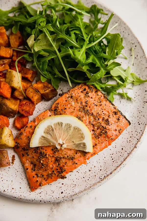 Zesty Peppered Salmon 5 A beautifully plated Lemon Pepper Salmon, showcasing its crispy skin and tender flesh, ready to be enjoyed.