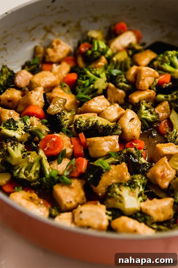 Zesty Lemon Chicken and Crisp Vegetable Stir-Fry 5 Lemon Chicken & Vegetable Stir Fry simmering in a pan, coated in a rich sauce.
