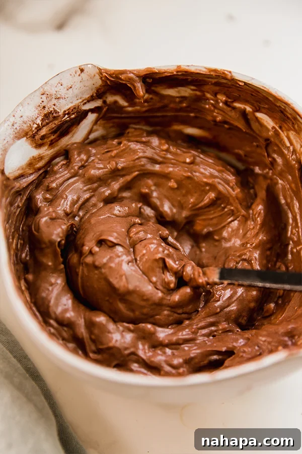 A close-up shot of the rich, smooth chocolate icing, perfectly prepared for frosting the paleo vegan chocolate cake.