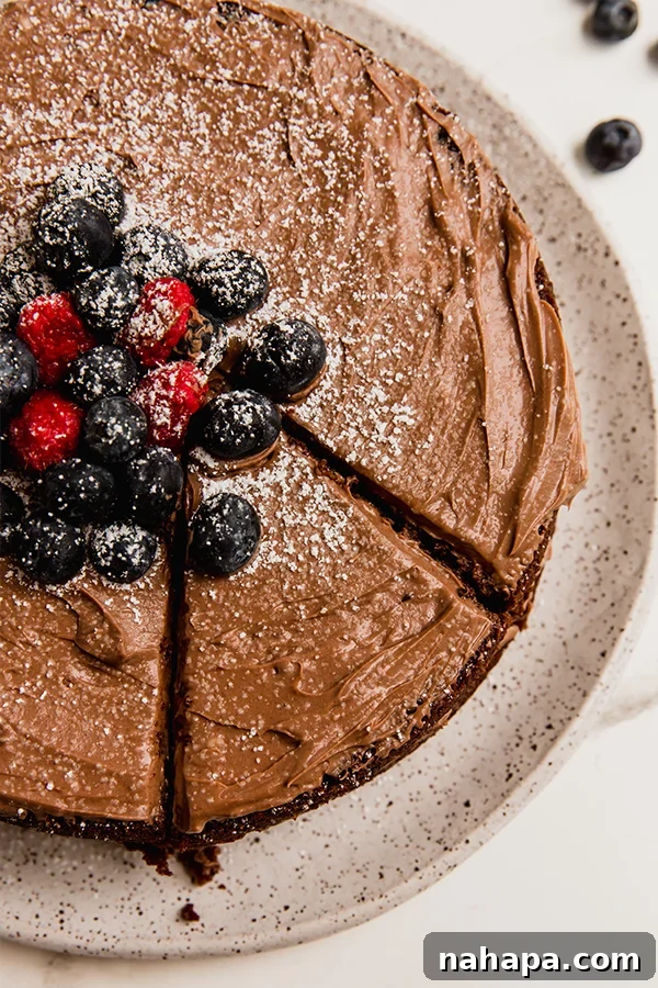 A full view of the assembled paleo vegan chocolate cake, elegantly frosted and ready to be enjoyed, promising a delightful treat.