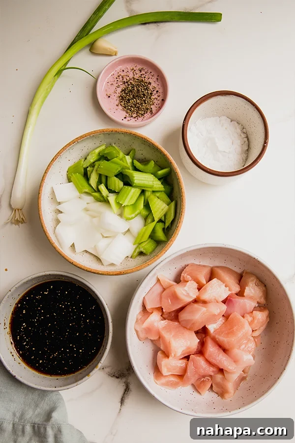 Two bowls of black pepper chicken stir fry side by side.