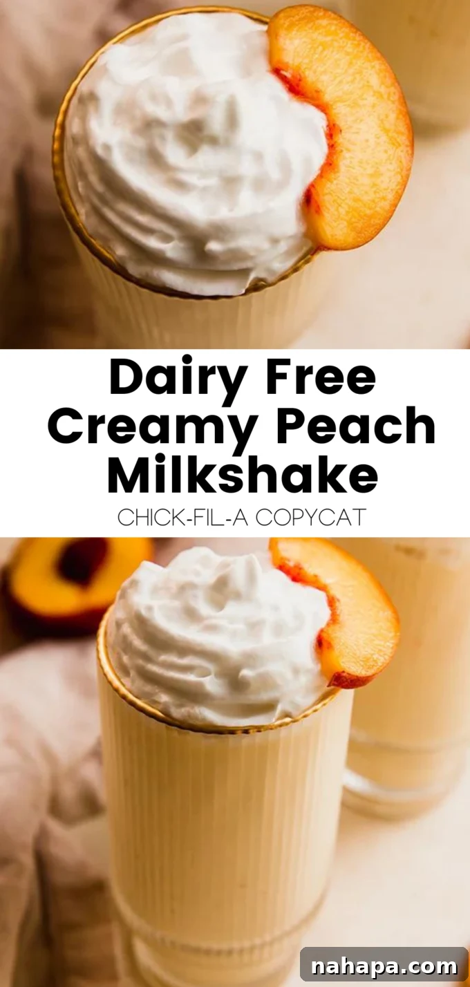 A beautifully presented, tall glass of dairy-free creamy peach milkshake, garnished with fresh peaches and a hint of mint, resting on a wooden surface. The focus highlights the luscious texture and appetizing color of the milkshake.