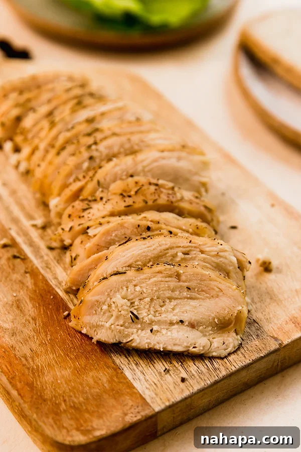 A close-up of beautifully seasoned homemade chicken breast ready for the oven.