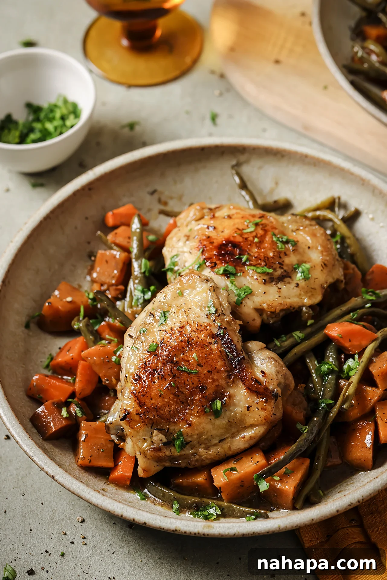 Hearty Slow Cooker Balsamic Chicken and Mixed Vegetables 2 A vibrant bowl of slow cooker balsamic chicken and roasted vegetables, showcasing tender chicken thighs with crispy skin, sweet potatoes, carrots, and green beans, garnished with fresh parsley.