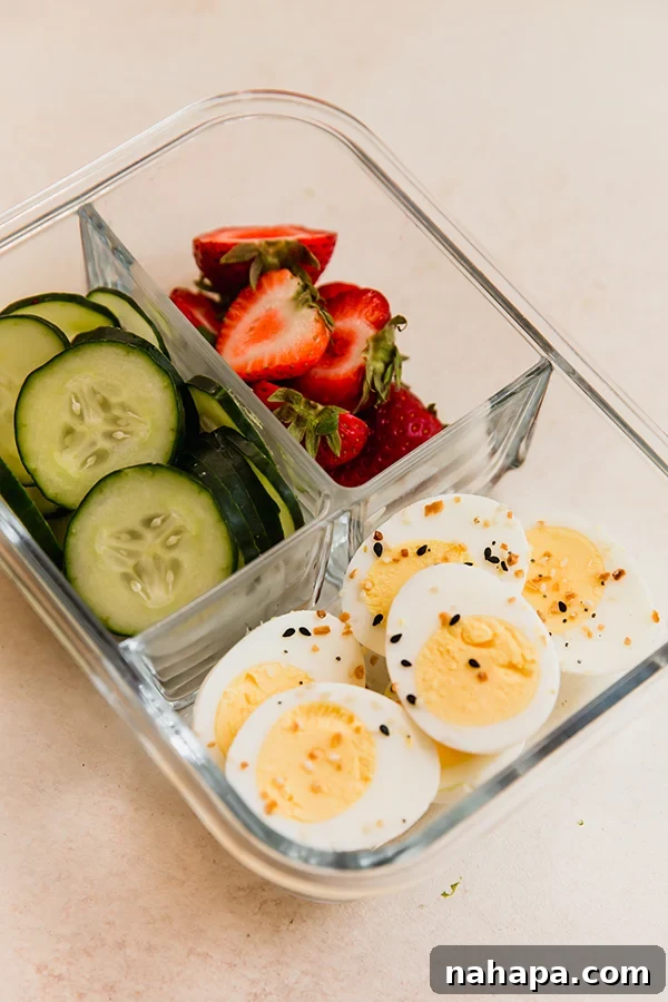 Everything Egg Bagel Lunchable, featuring sliced hardboiled eggs, cucumber, and strawberries.