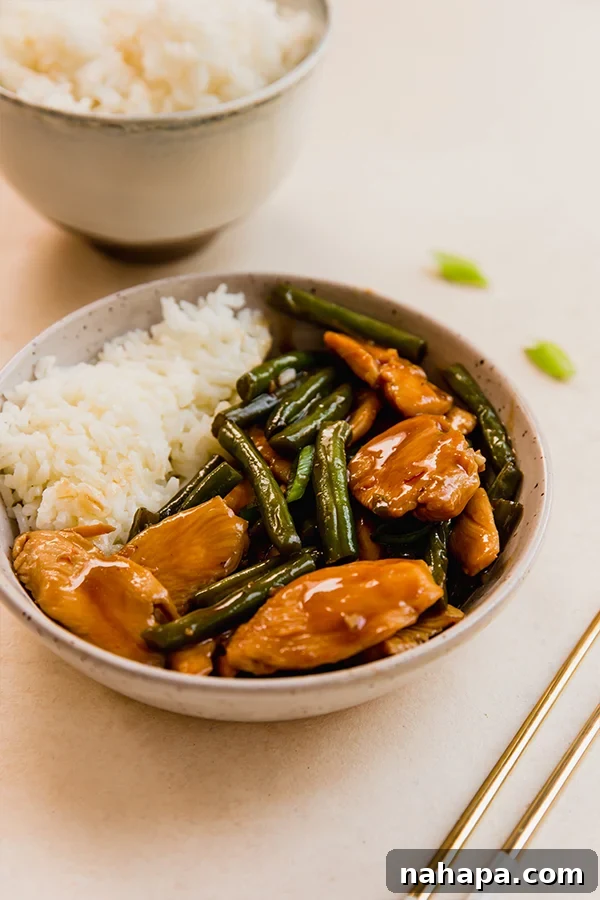 String Bean Chicken served in a bowl with rice, ready to enjoy