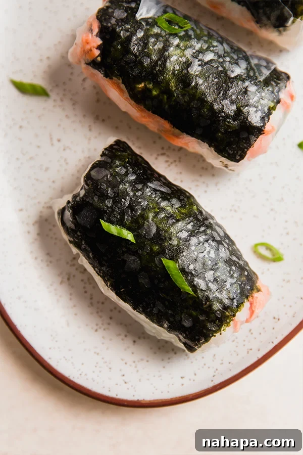 A serving plate with sushi-inspired salmon rice paper rolls.