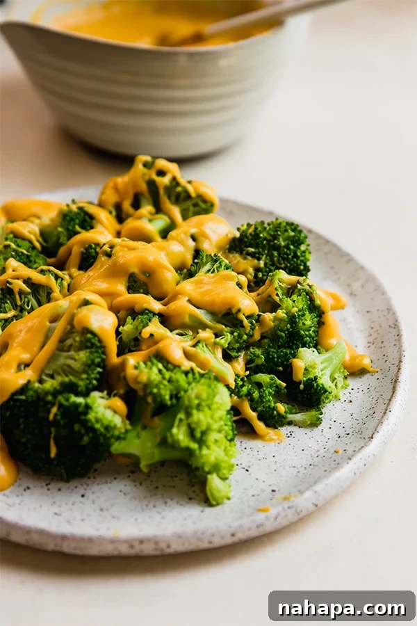 Vegetables on a plate with dairy free cheese sauce over it