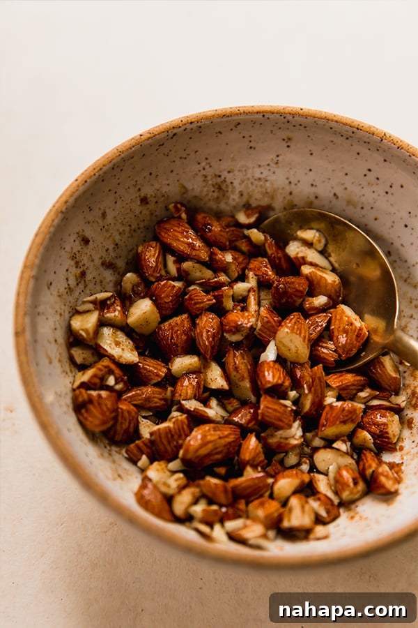 Warm Air Fryer Apples with Dairy-Free Ice Cream 4 Chopped almonds coated in a ghee mixture as part of the recipe for air fryer baked apples.