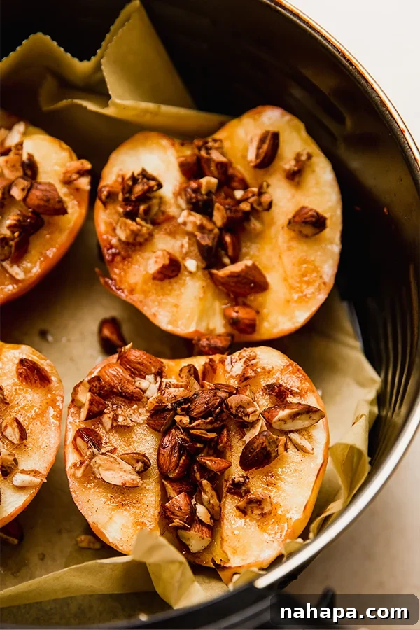 Warm Air Fryer Apples with Dairy-Free Ice Cream 7 The apples in the air fryer with toppings, looking golden and ready.