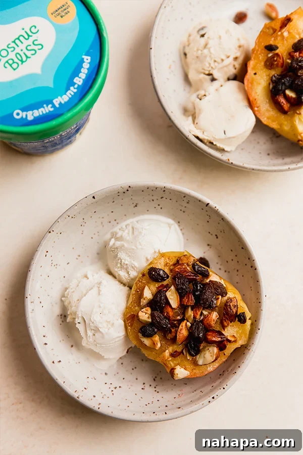 Warm Air Fryer Apples with Dairy-Free Ice Cream 8 A bowl of air fryer "baked" apples with ice cream, raisins, and toasted almonds.