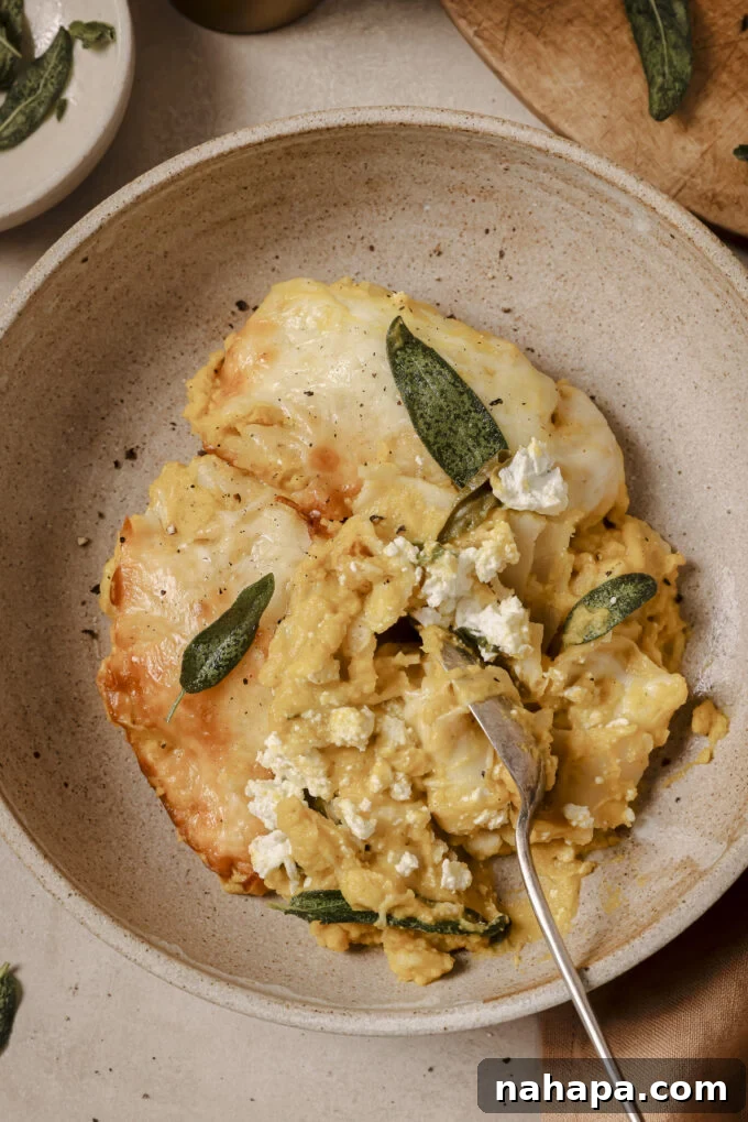 Butternut lasagna roll ups topped with crispy sage in a bowl