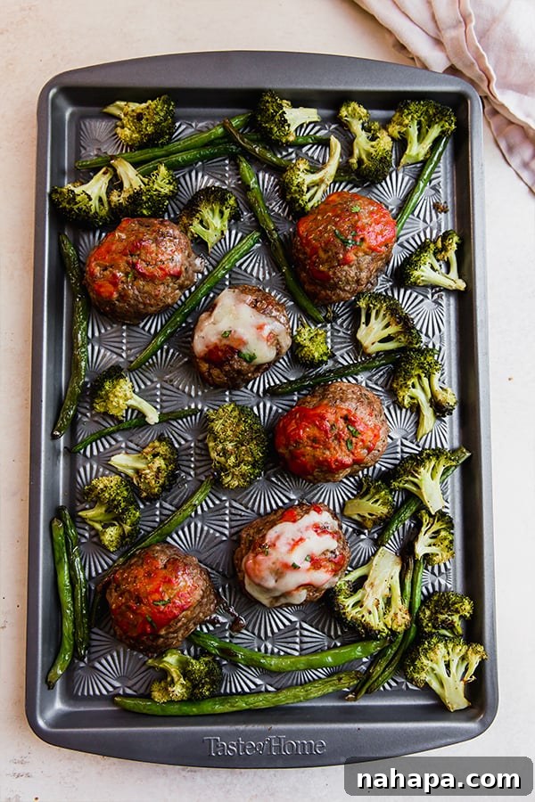 One-Pan Italian Mini Meatloaf & Roasted Vegetables (Gluten & Dairy-Free) 5 A freshly baked Italian-Style Mini Meatloaf & Vegetable Sheet Pan, showcasing perfectly cooked meatloaves with melted cheese and roasted vegetables.
