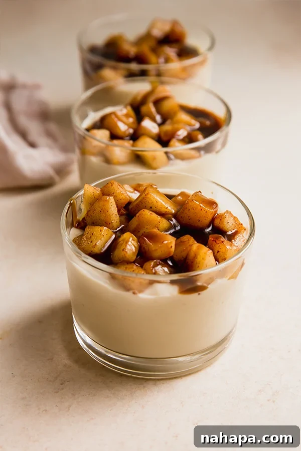 Cups of dairy-free caramel vanilla pudding with sautéed apples and caramel topping.