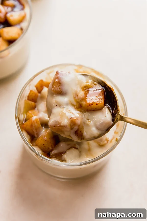 A cup of caramel vanilla pudding with a spoon inserted, ready to be eaten.